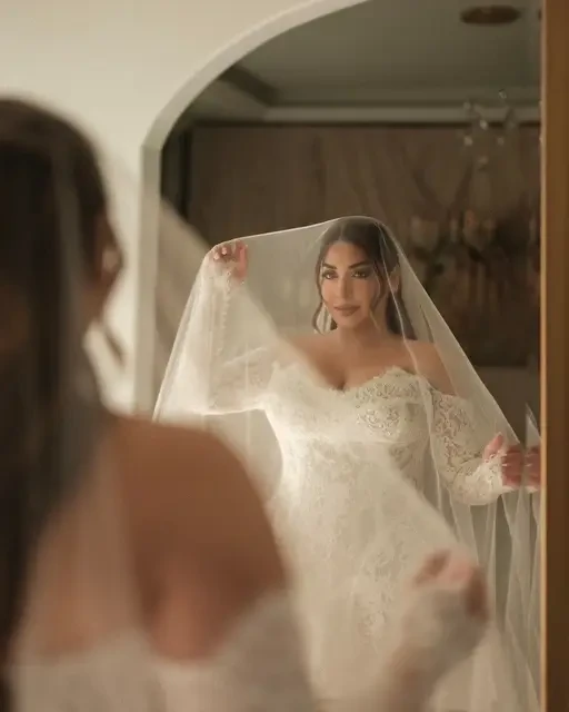 Hasmik Wears a Romantic Lace Bridal Gown with Long Sleeves Image