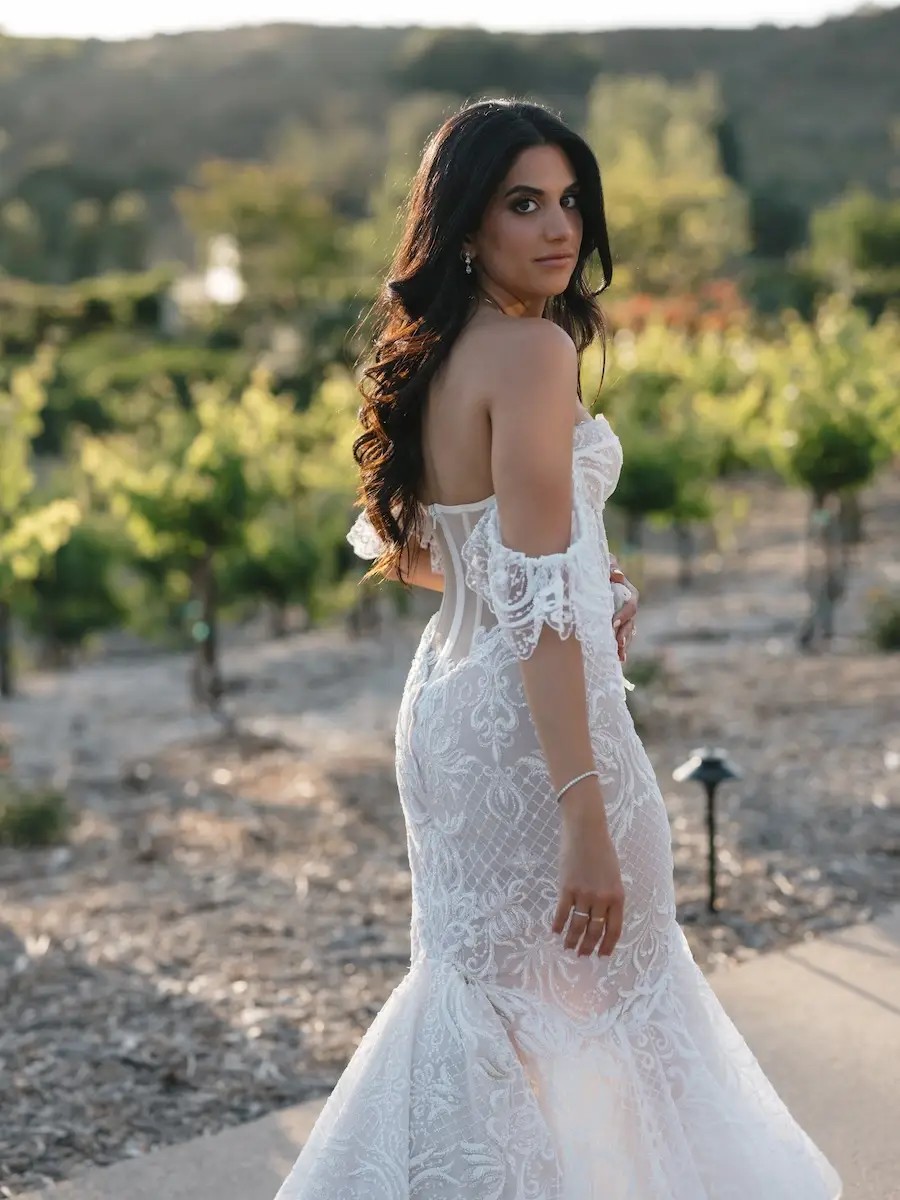 Leila Wears Fitted Lace Wedding Dress With Off The Shoulders Straps. Desktop Image